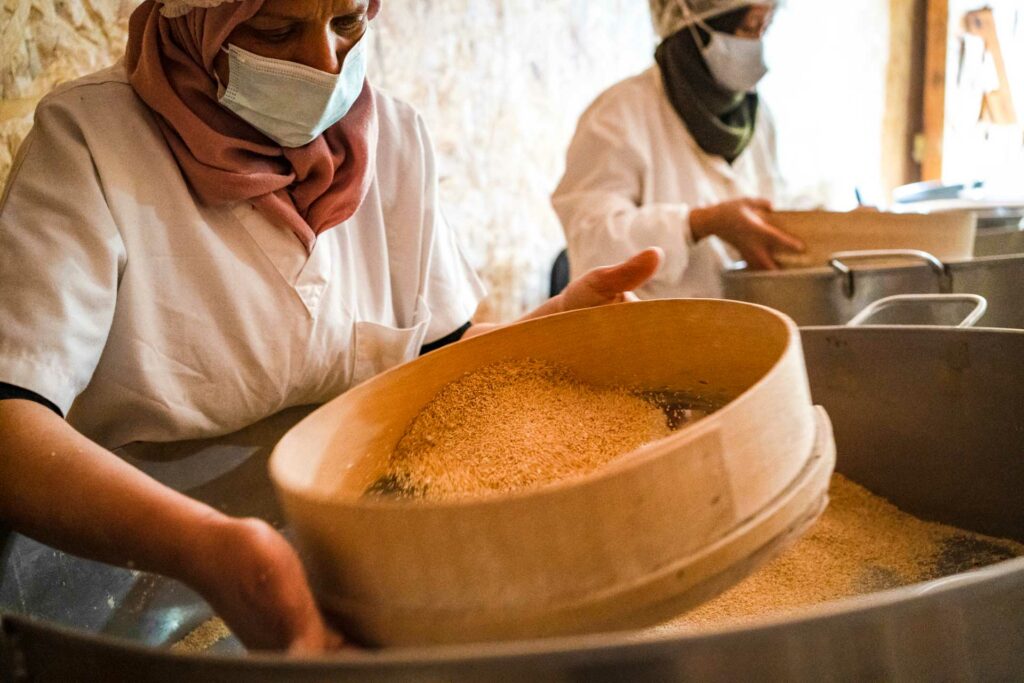 DLella Kmar Cooperative employees sorting mahmoudi durum wheat seeds. Credit: Julia Terradot